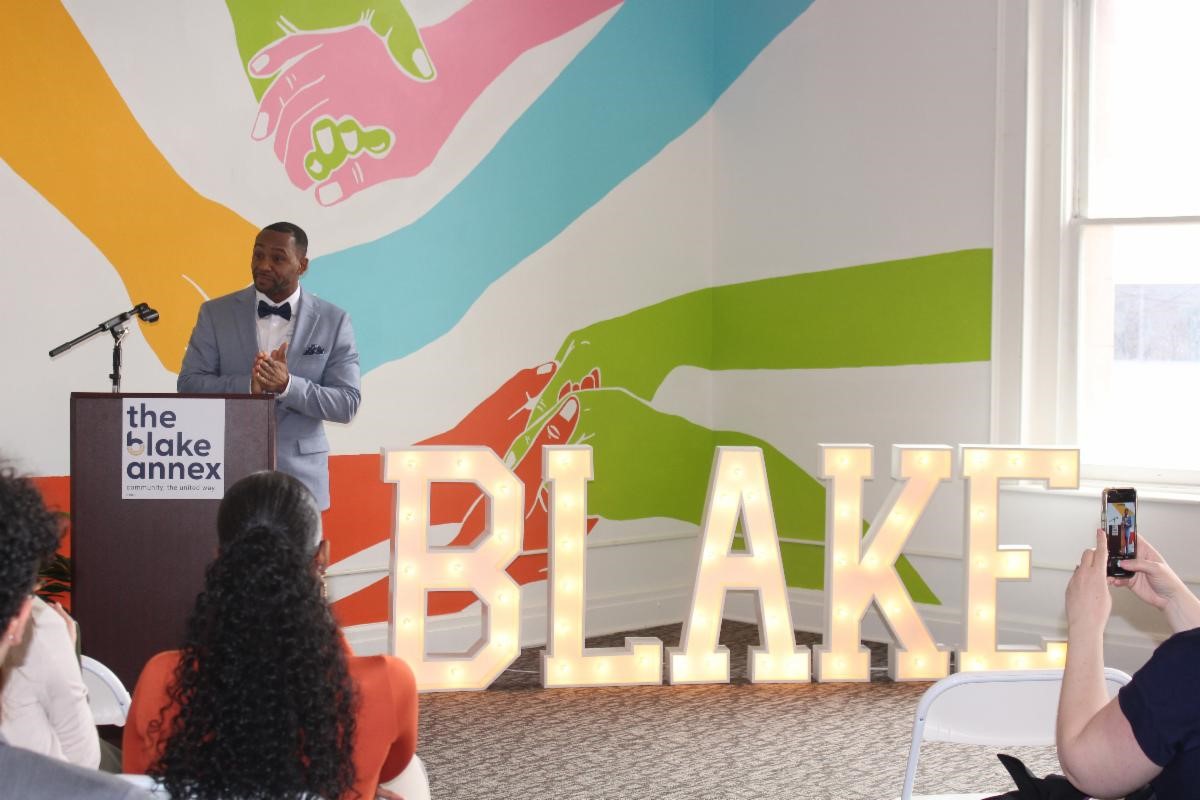 Angelo Maddox in front of the Blake sign