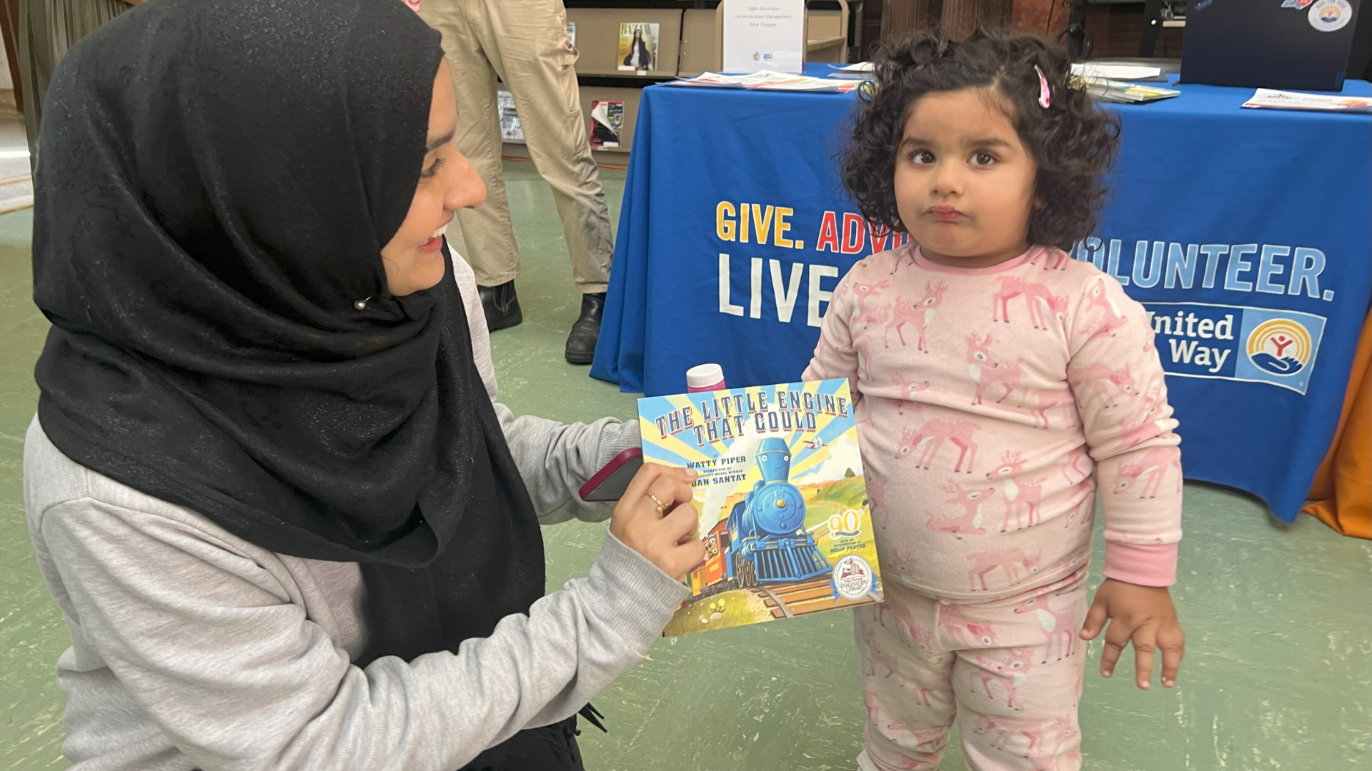Mother giving daughter new book