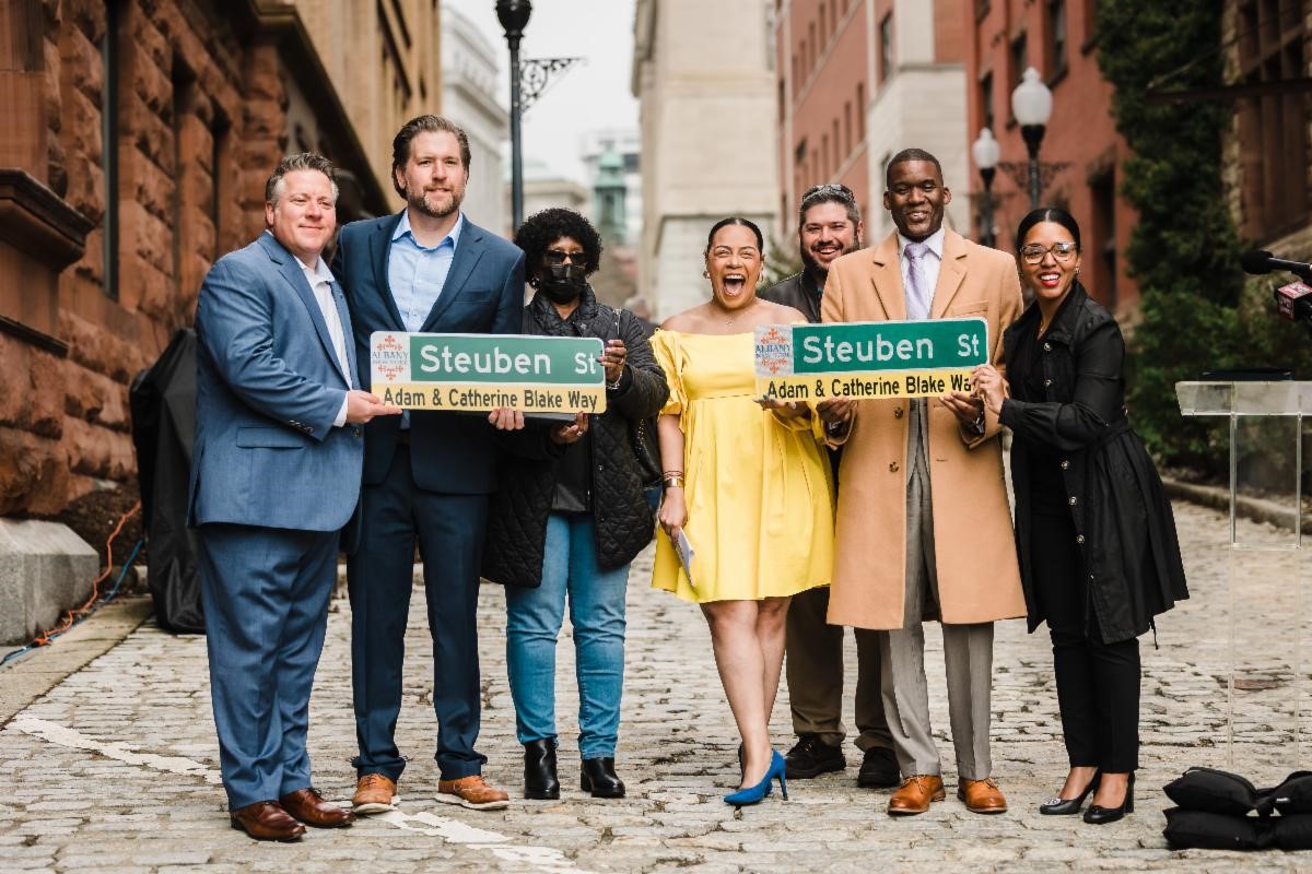 Public leaders holding new street signs