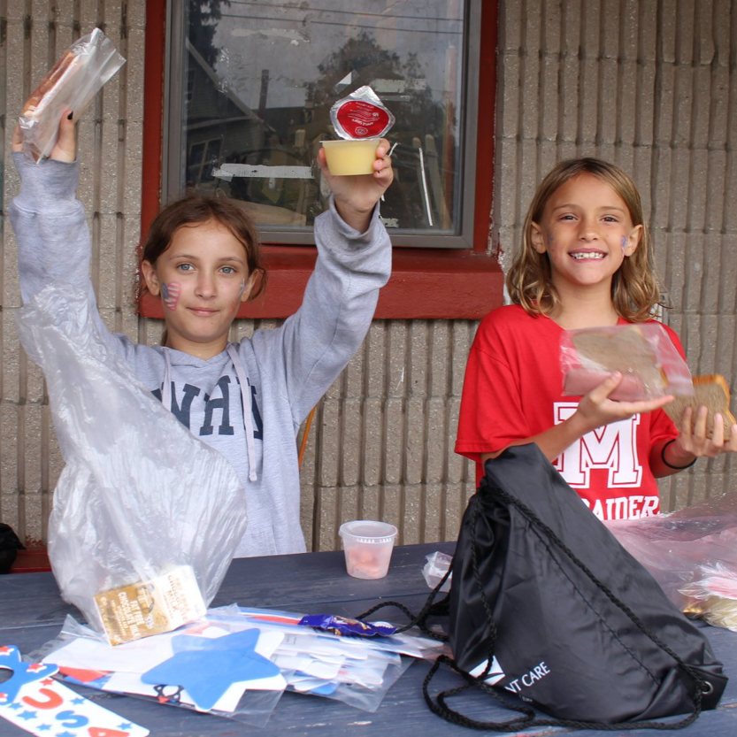 Two girls showing their lunch