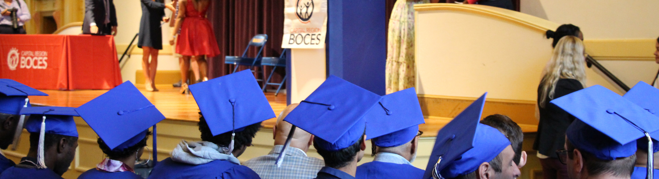 Graduates facing stage