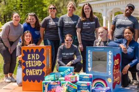 Group photo infront of period poverty boxes they just painted