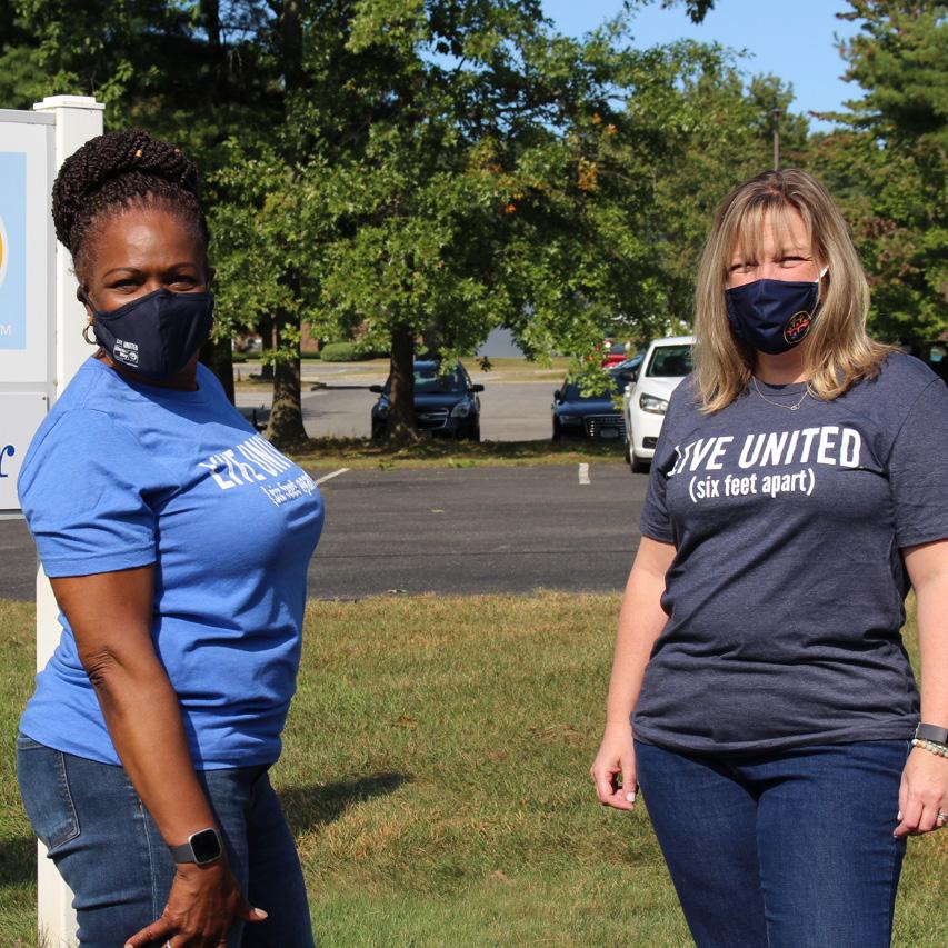 2 women in Live United (six feet apart) shirts