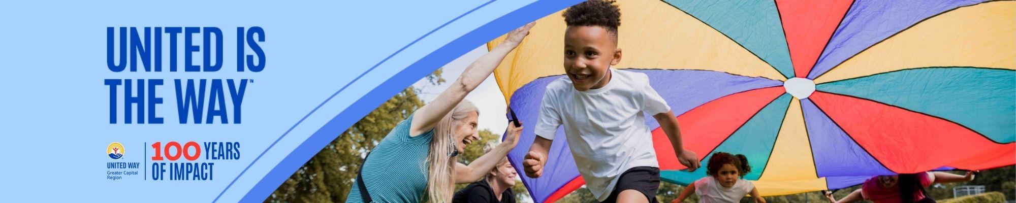 United is the Way Banner with a happy kid running under a parachute