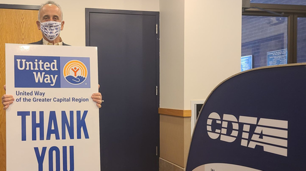 Carm Basile, CDTA CEO holding Thank You Sign