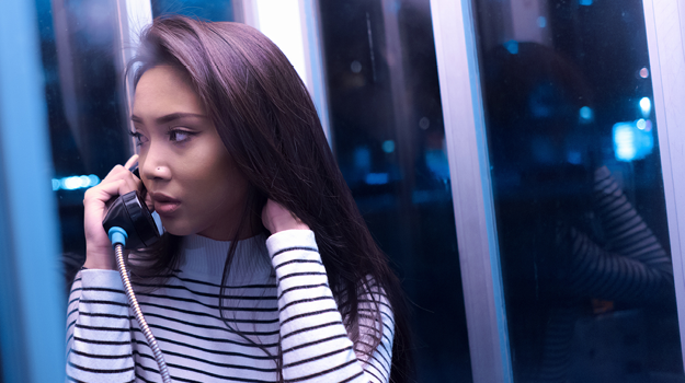 Women on phone in toll booth