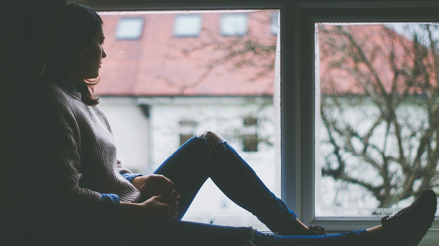 Girl sitting in windowsil