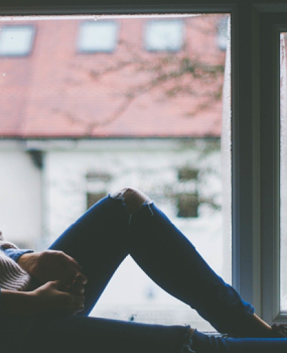 Girl sitting in windowsil