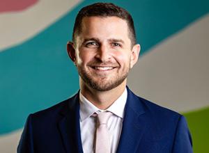 Man smiling in blue suit