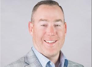 Man smiling in gray suit