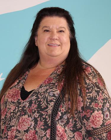 Bonnie smiling in floral shirt