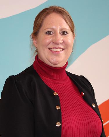 Erin in Red top and black blazer smiling